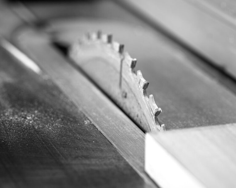 A table saw blade in motion cutting a panel