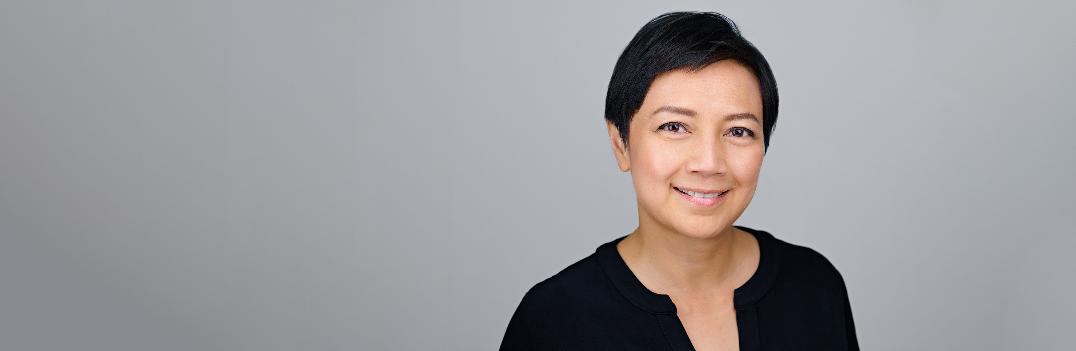 Corporate headshot of a confident professional used as a background image—conveying brand alignment, poise, and the polished results companies expect from DJB Photography.