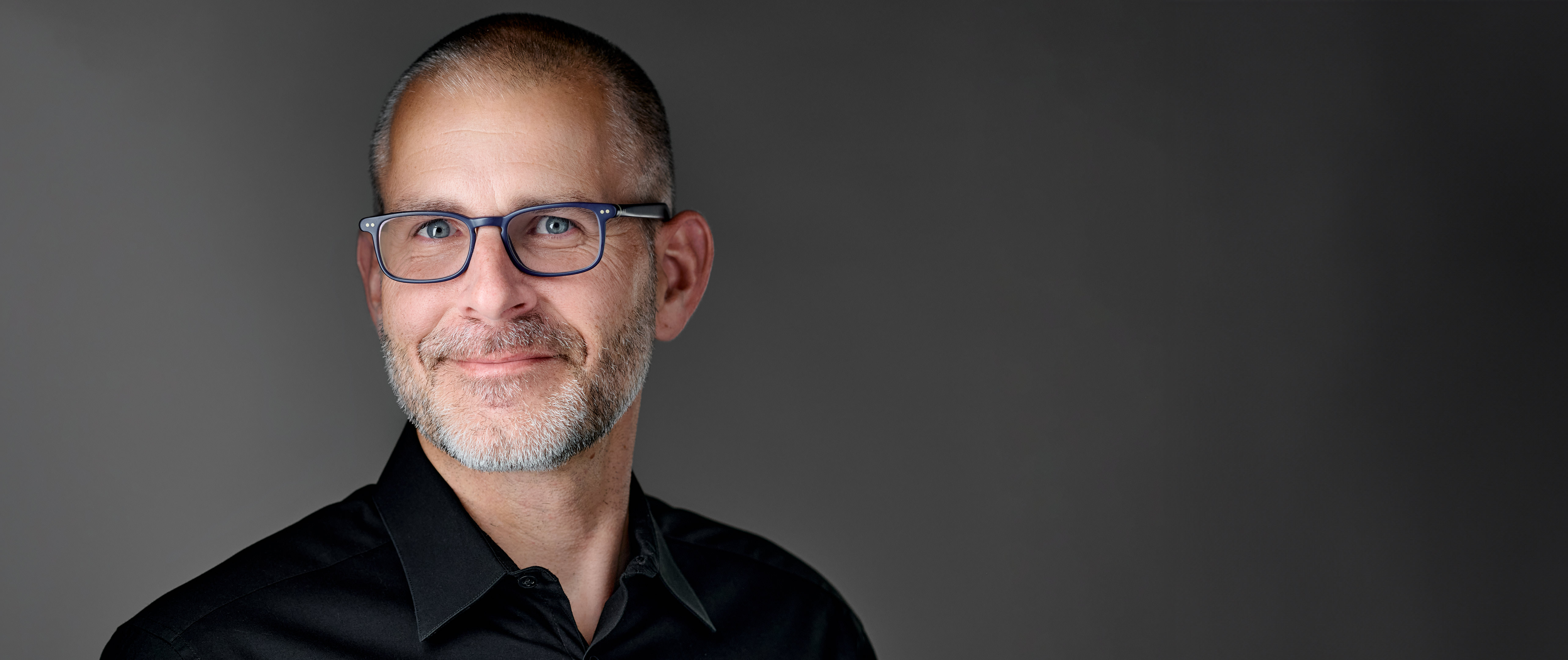 Headshot of Chris Edgette, presenting poised leadership and authenticity—captured to align with his role in Stanford's innovation and communication spaces.