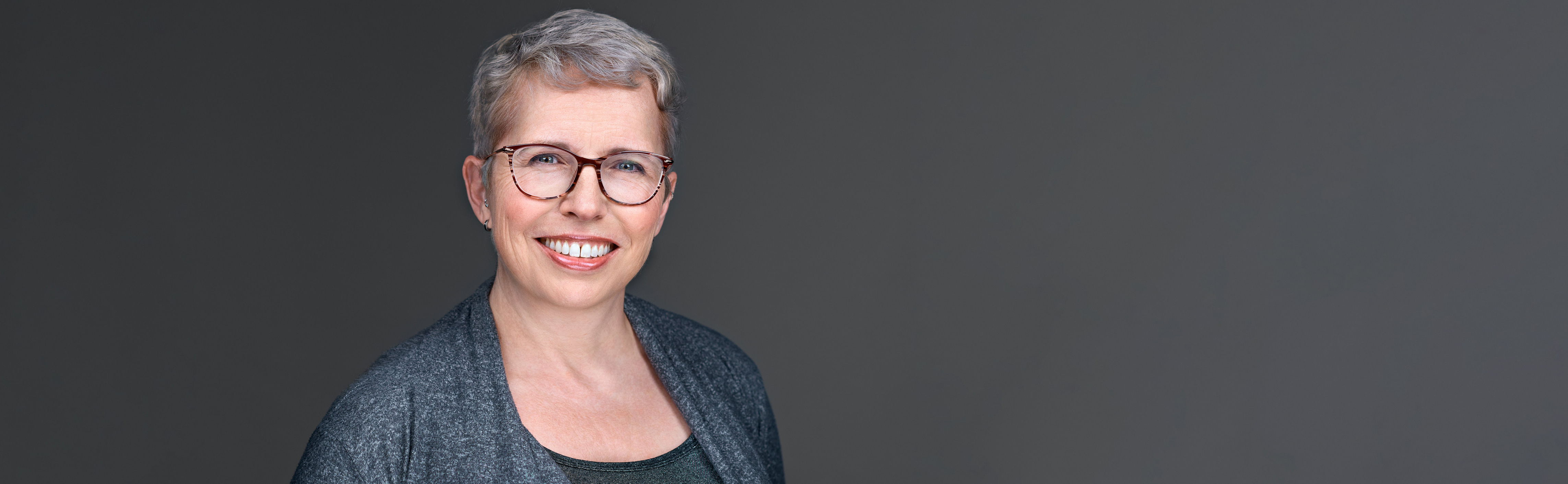 Headshot of Cherie Goodenough, smiling warmly and naturally—portraying ease, approachability, and professional confidence in an academic or research setting