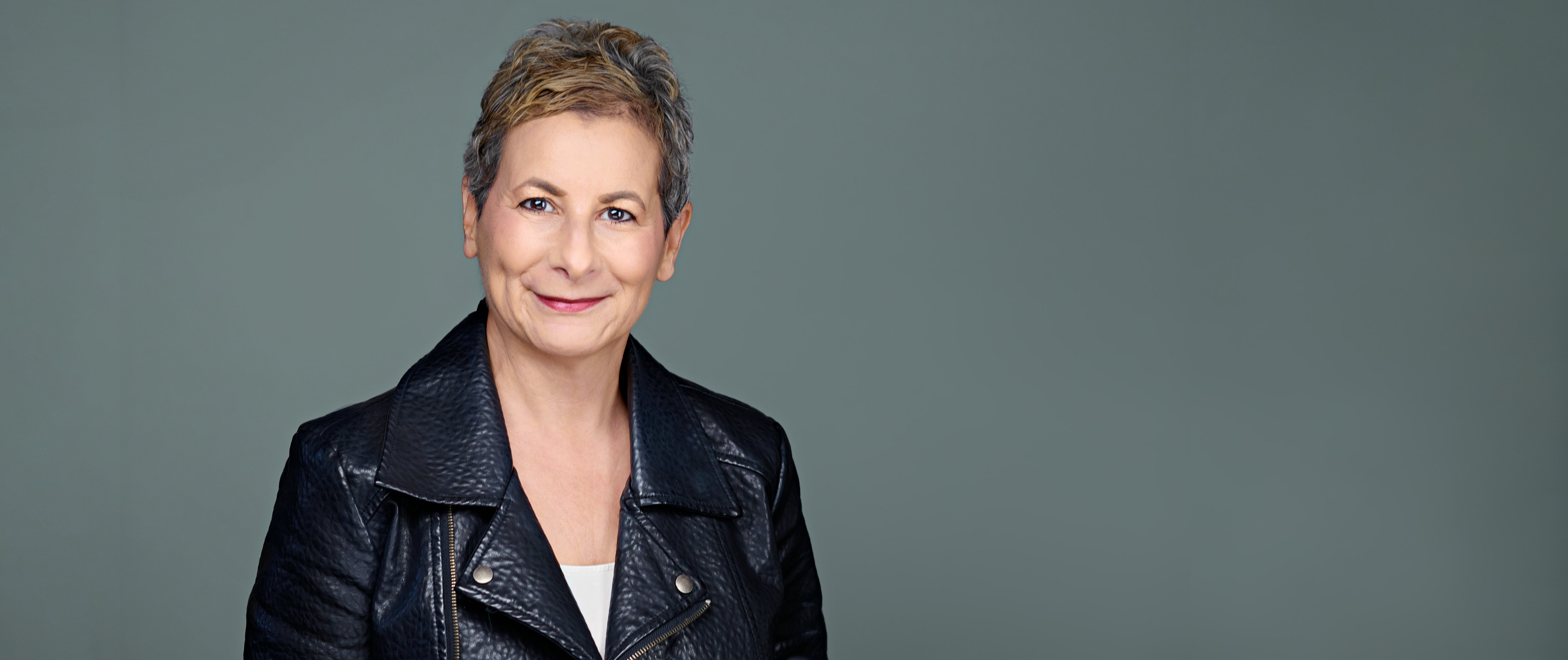Headshot of Sabrina Alfin, looking composed and approachable—captured to reflect professional poise and warmth.