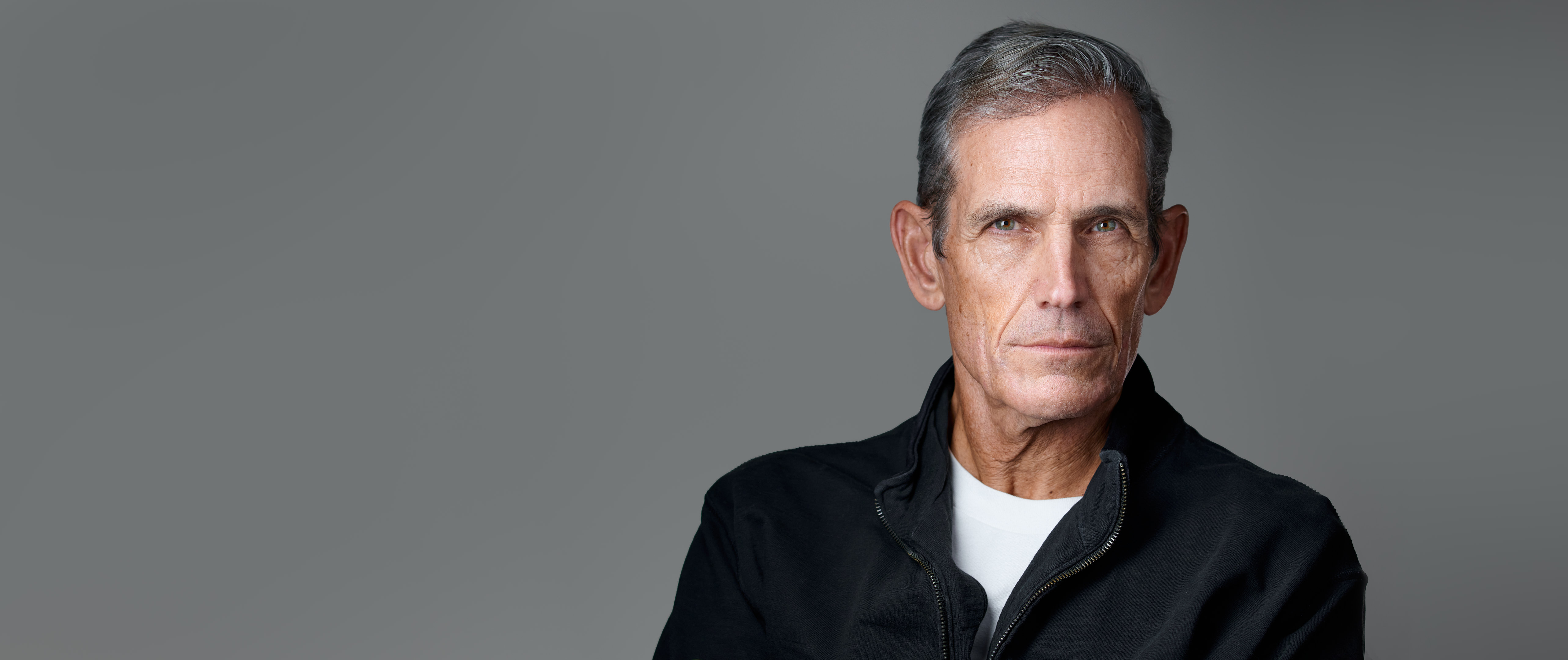 Headshot of Marcus Stock, looking directly at the camera with confidence and clarity—crafted to convey presence, connection, and professional polish.