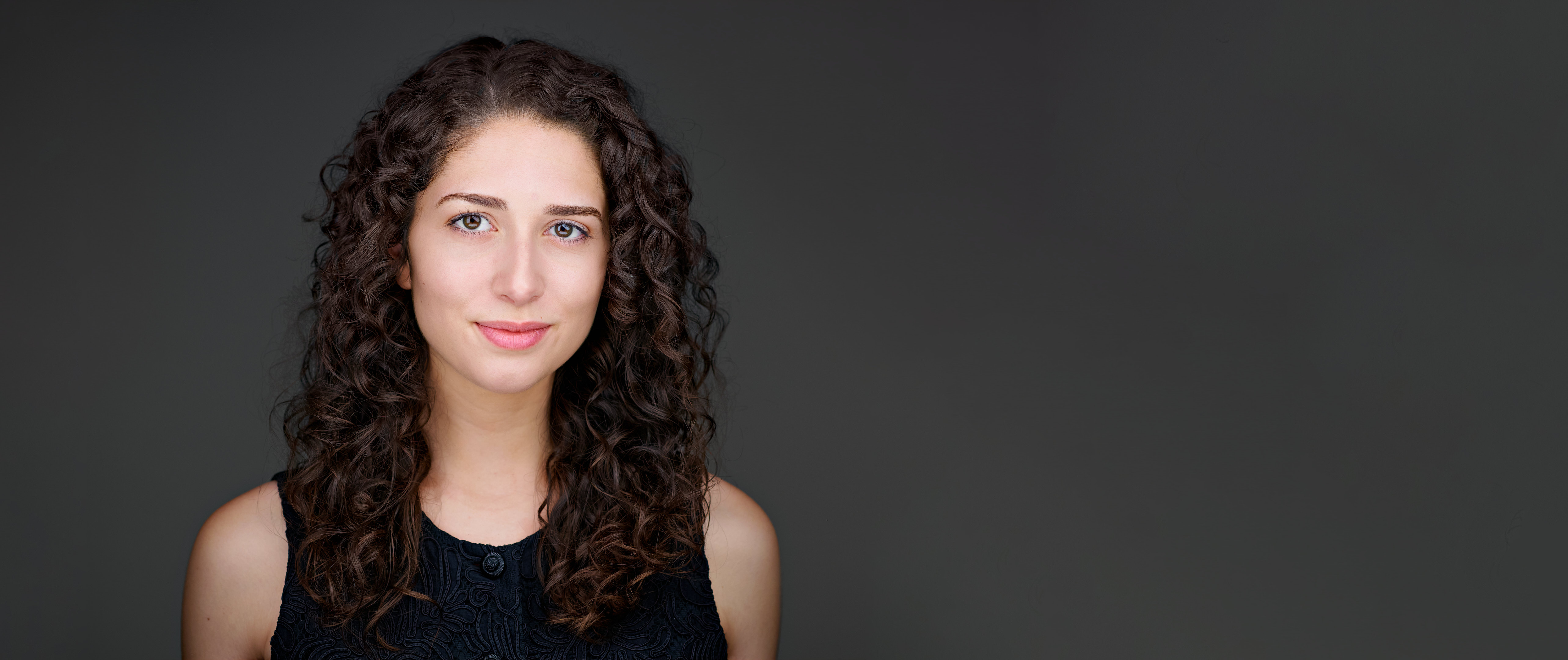 Headshot of Monica Slater, relaxed and composed—projecting clarity, assurance, and a professional tone ideal for high-visibility roles.