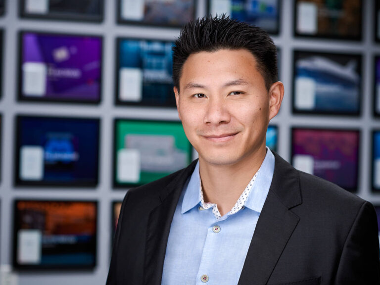 usiness professional in black blazer and light blue shirt, photographed by Dean Birinyi for company headshots in Palo Alto.