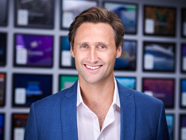 Business professional in blue blazer and white shirt, photographed by Dean Birinyi for company headshots in Palo Alto.