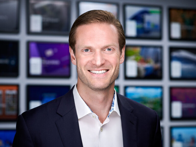Business professional in dark blazer and white shirt, photographed by Dean Birinyi for company headshots in Palo Alto.