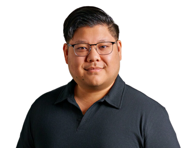 Business professional in dark polo shirt and glasses, photographed by Dean Birinyi for company headshots in Palo Alto