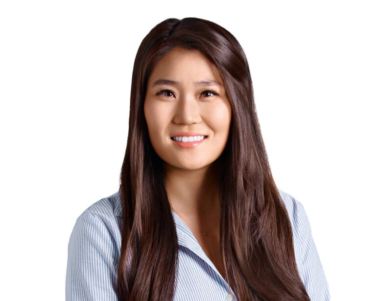 Professional woman in striped shirt, photographed by Dean Birinyi for company headshots in Palo Alto.