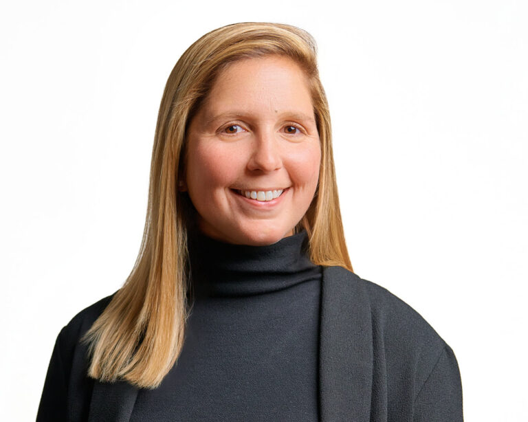 Professional woman in black turtleneck and jacket, photographed by Dean Birinyi for company headshots in Palo Alto.