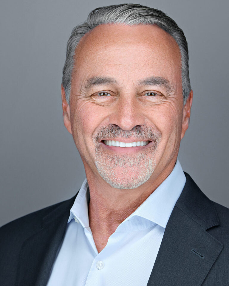 Smiling senior professional man in a dark blazer and light shirt – company headshot by Dean Birinyi in Palo Alto for Silicon Valley business branding.