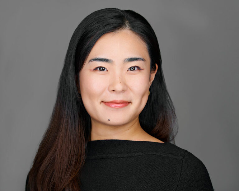 Smiling woman in a black top, professionally photographed by Dean Birinyi for a company headshot session in Palo Alto, Silicon Valley.