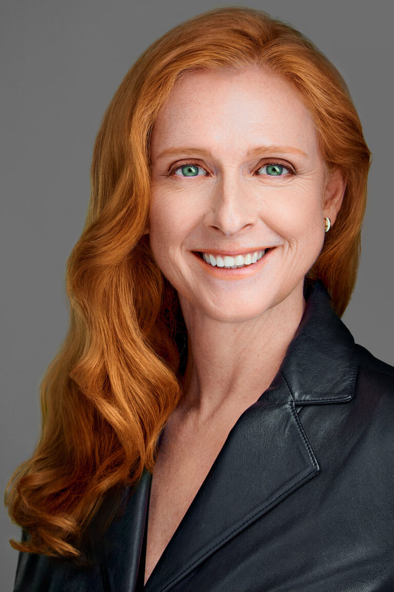 Professional headshot of a woman in a leather blazer, photographed by Dean Birinyi in Palo Alto.