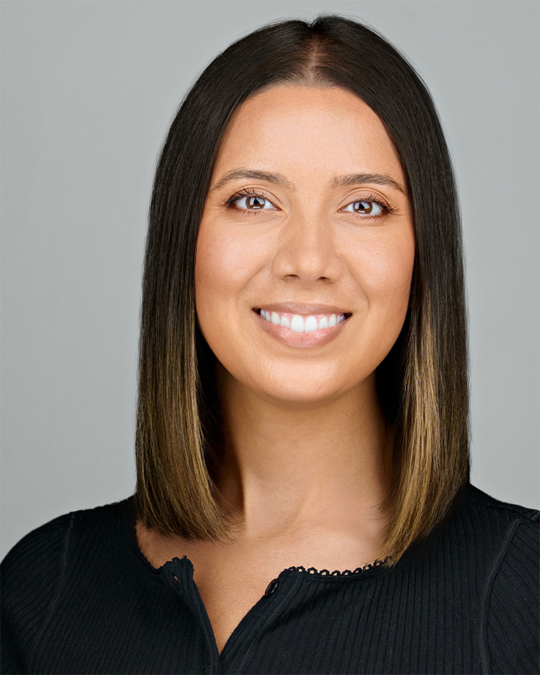 Professional headshot of a smiling executive assistant with sleek shoulder-length hair, wearing a black top—styled for a company photo session in Santa Clara.