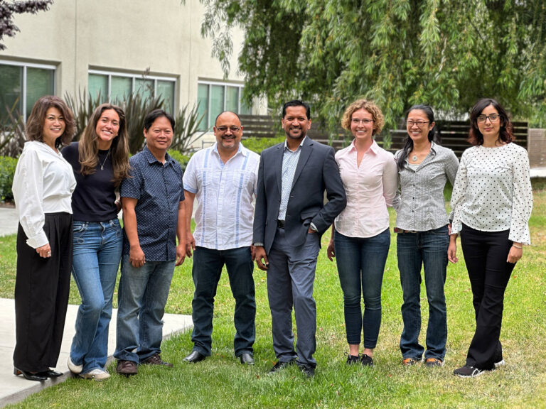 Group of Redwood City professionals standing outdoors, dressed in business casual attire, photographed for corporate headshots by Dean Birinyi