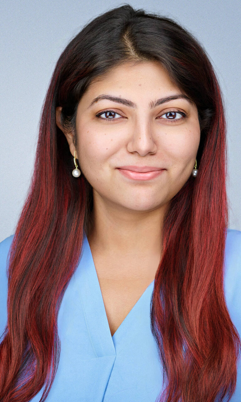 Professional corporate headshot of a woman with long red hair wearing a light blue blouse, photographed by Dean Birinyi Photography in Santa Clara, California. Displayed on the company headshot system page to represent inclusive, consistent portraits for Bay Area corporate teams.
