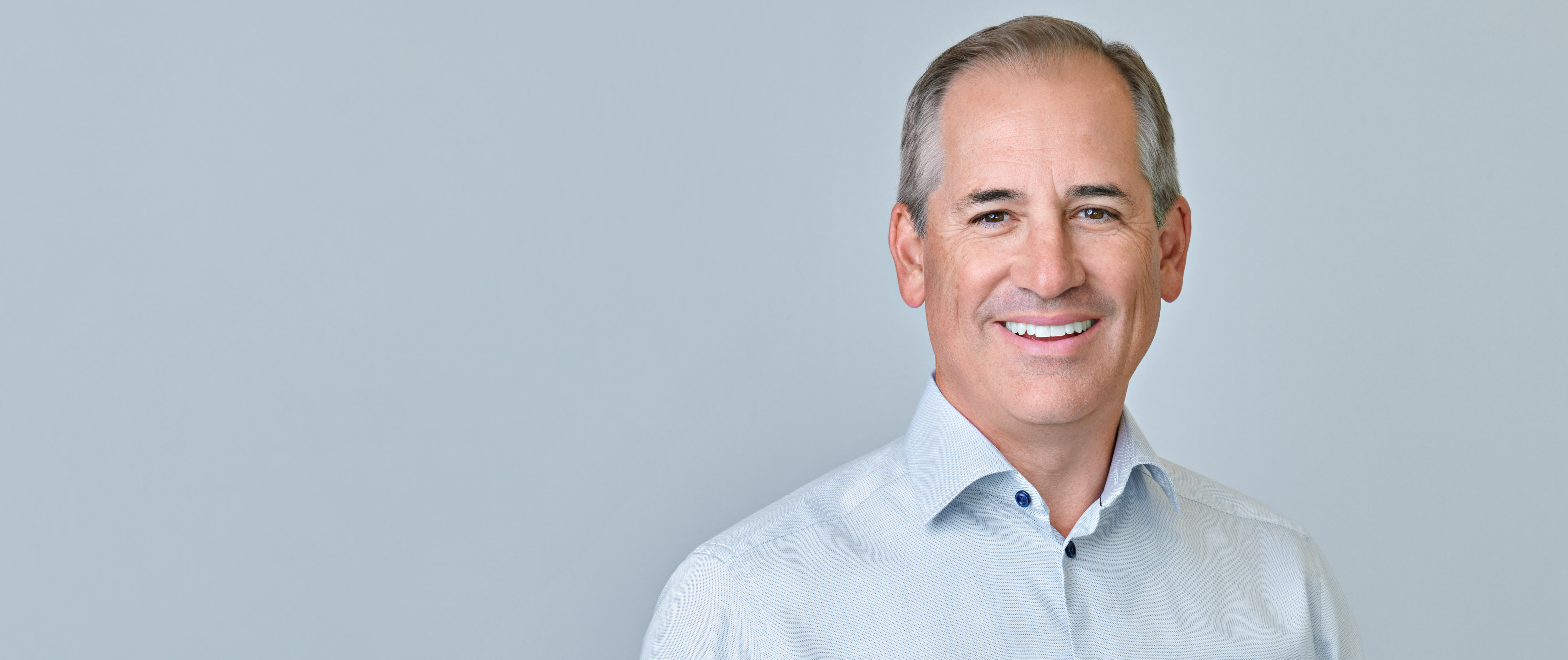 Professional headshot photographed in Palo Alto with soft studio lighting and a neutral light gray background, representing the consistent, contemporary style used for new-hire headshots across Silicon Valley companies.