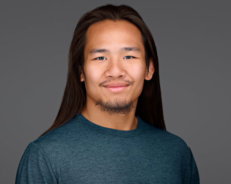 Professional headshot on a neutral dark background, photographed in Palo Alto for corporate and tech teams.
