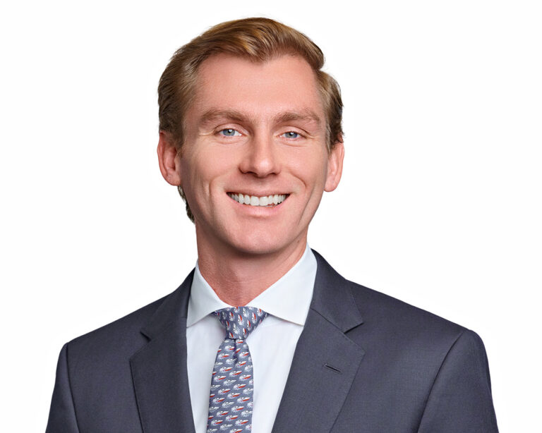 Professional corporate headshot of a man in a suit, photographed on a clean white background with polished studio lighting in Palo Alto.