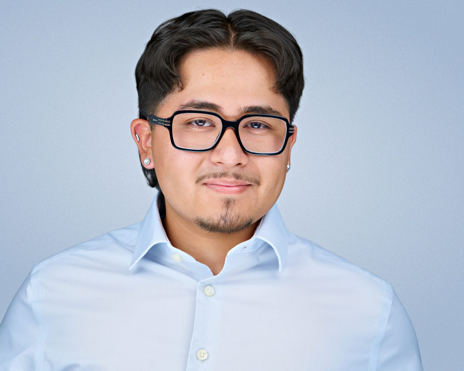 Professional headshot of a man photographed in Silicon Valley with soft studio lighting and a clean light-gray background.