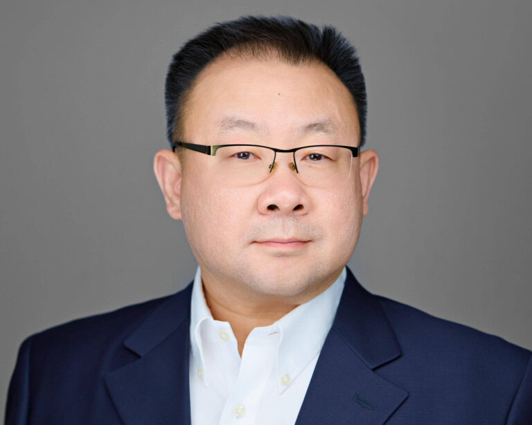 Professional executive headshot of a senior leader photographed for corporate use