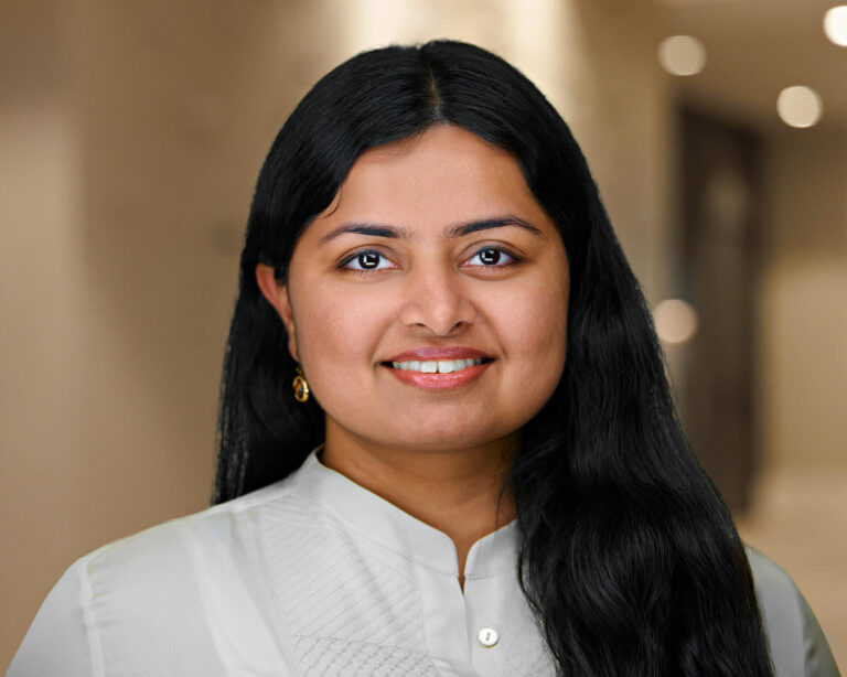 Professional corporate headshot of a woman in white blouse, photographed on location in San Mateo, California.