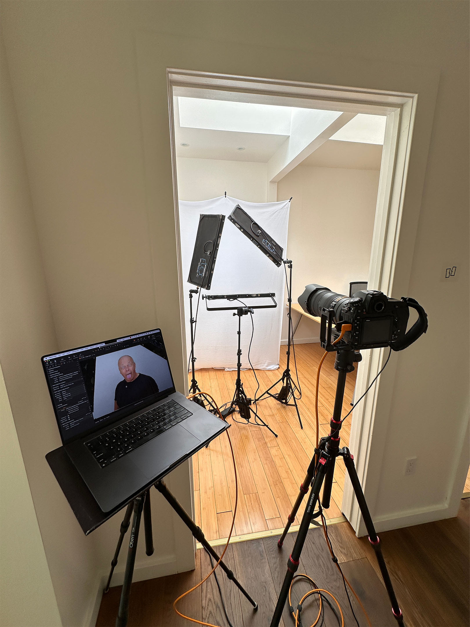 On-location corporate headshot setup inside San Mateo office with camera, lighting, and backdrop.