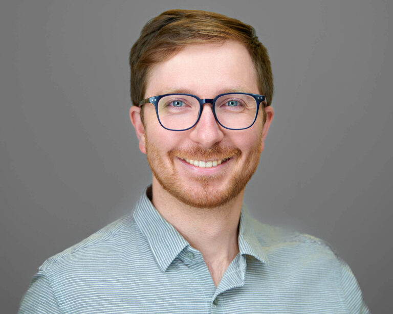 Corporate headshot of a male professional with glasses and striped shirt, photographed on location in San Mateo, California.