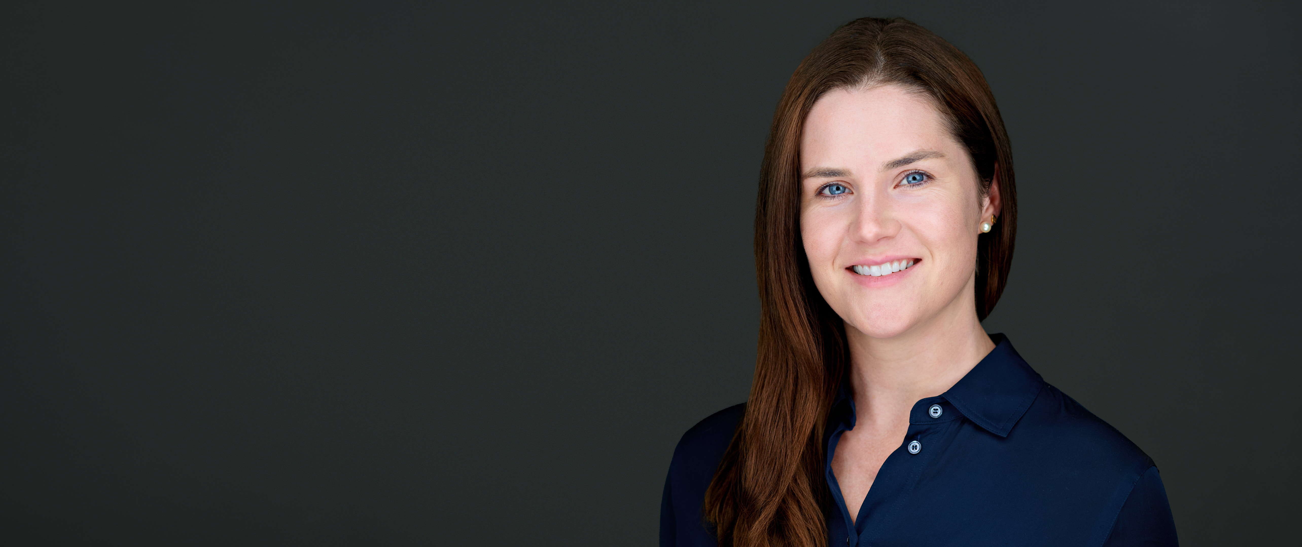 On-location corporate headshot of a professional woman with long brown hair, photographed in San Mateo, CA.