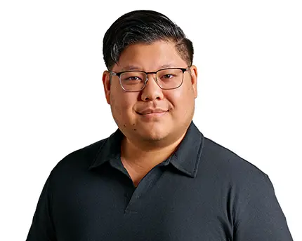 Business professional in dark polo shirt and glasses, photographed by Dean Birinyi for company headshots in Palo Alto