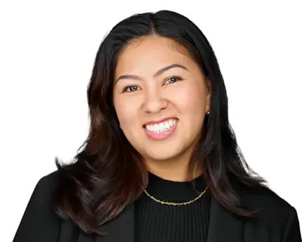 Professional headshot of a team member in black attire on a white background, representing polished company headshots photographed on location.