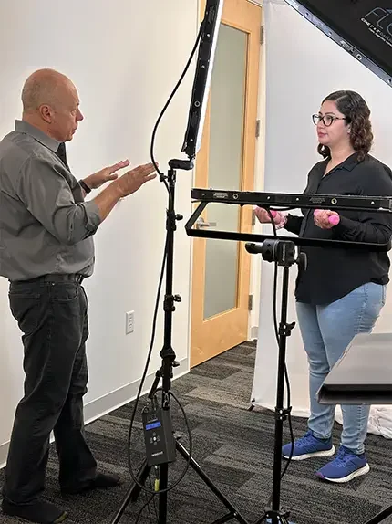 Professional headshot photographer guiding a client during a studio session in Fremont.