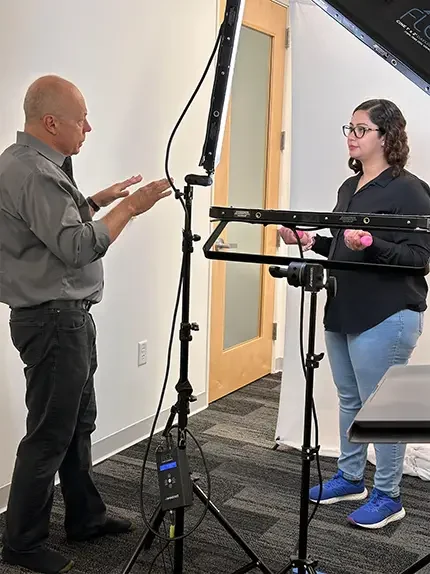 Photographer Dean Birinyi guiding a client during a professional headshot session in Santa Clara, emphasizing a collaborative and personalized approach.