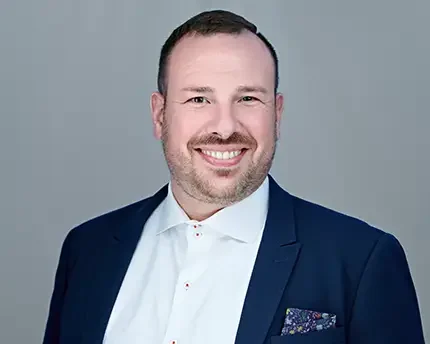 Man in a navy blazer and white shirt smiling in a professional headshot by Dean Birinyi, photographed in Palo Alto for Avails Medical.